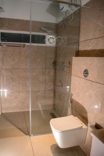 a bathroom with a shower and a toilet at Horizon Nest in Agatti