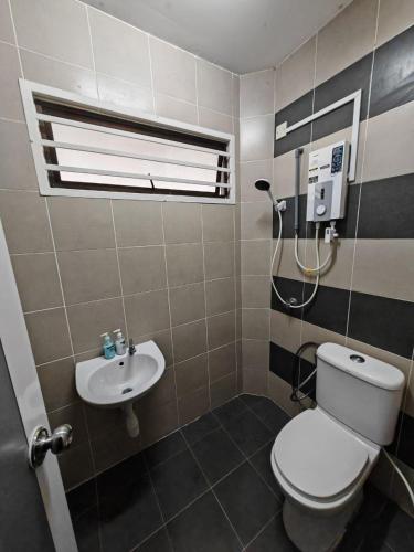 a bathroom with a toilet and a sink at PORT DICKSON HomeStay, Family 2 BR Netflix Wifi in Port Dickson