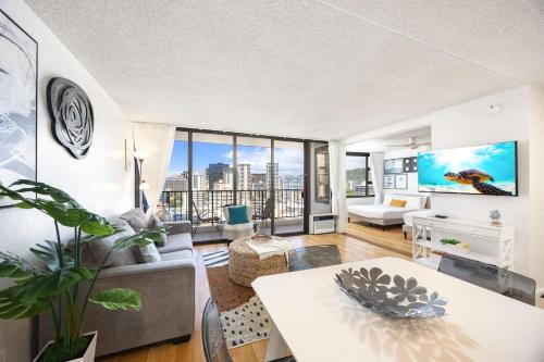 a living room with a couch and a table at 17FL Fully Renovated, 5 mins to Beach with Parking in Honolulu