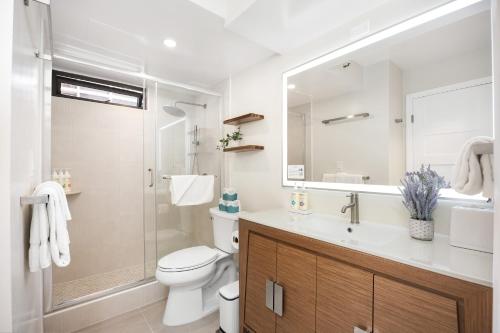 a bathroom with a toilet and a sink and a shower at 17FL Fully Renovated, 5 mins to Beach with Parking in Honolulu
