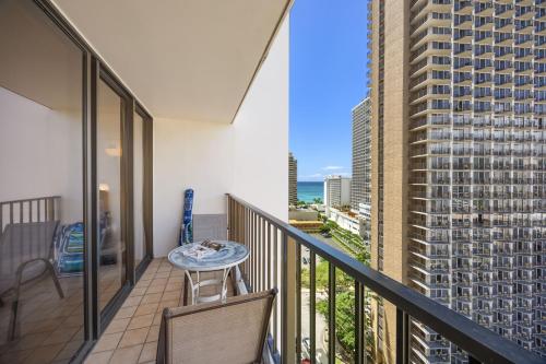 a balcony with a table and a view of a city at 17FL Fully Renovated, 5 mins to Beach with Parking in Honolulu