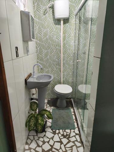 a bathroom with a sink and a toilet and a shower at Canto da restinga in Paranaguá