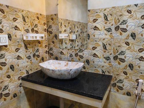 a bathroom with a bowl on top of a counter at Eva Beach Side Room in Mandrem