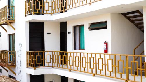a building with balconies and a fire extinguisher at Hotel Diosa del Agua Bacalar in Bacalar