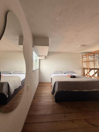 a bedroom with two beds and a window at Casaboa Apartamentos Passarela in Itacaré
