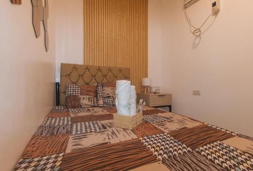 a bedroom with two beds with a bedspread on it at G Fam Transient by RedDoorz in Manila