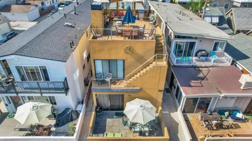 an aerial view of a house with a patio and a balcony at Contemporary Value Duplex with Rooftop Deck- 303 home in Newport Beach