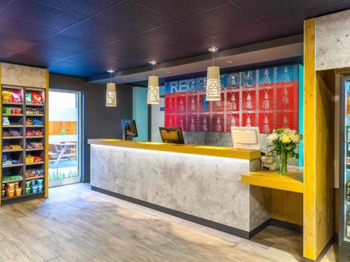 a lobby of a store with a reception counter at ibis budget Glasgow in Glasgow