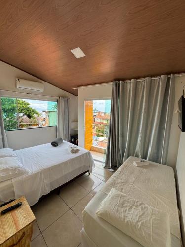 a bedroom with two beds and a window at Pousada Shamah - Morro de São Paulo in Morro de São Paulo