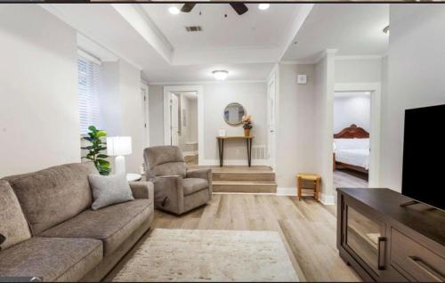 a living room with a couch and a tv at Savanna in Atlanta