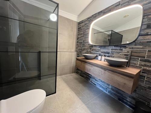 a bathroom with two sinks and a mirror at Aquaronde 108 in Lemmer