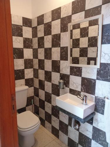 a bathroom with a toilet and a sink at Renzo 1 in Deán Funes