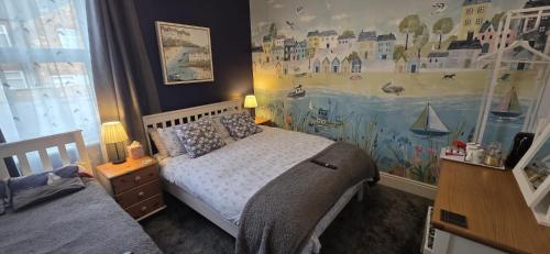 a bedroom with a bed and a painting on the wall at St Michael's Boutique Guest House, North Bay, Scarborough with free parking and fast wi-fi in Scarborough