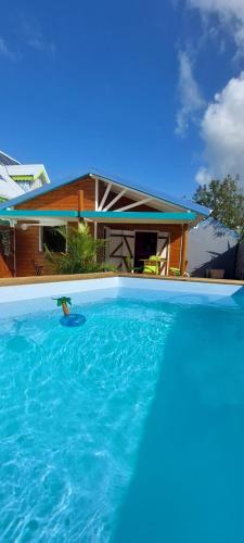 a house with a swimming pool in front of a house at Bungaillou in Lamentin