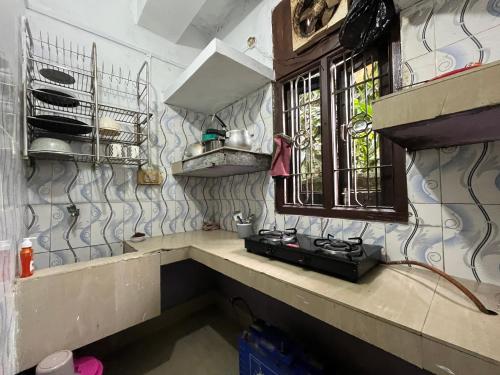 a kitchen with a sink and a window at Anigo Cottage Naharlagun in Bacha