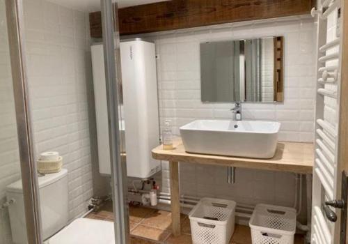 a bathroom with a sink and a toilet at Le verger in Vébron