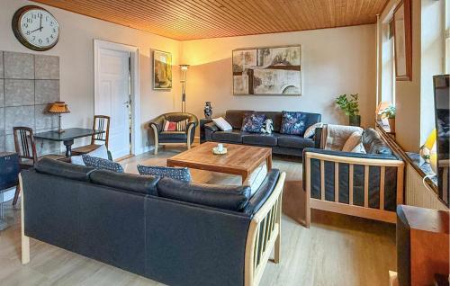 a living room with a couch and a table at 4 Bedroom Gorgeous Home In Stege in Stege