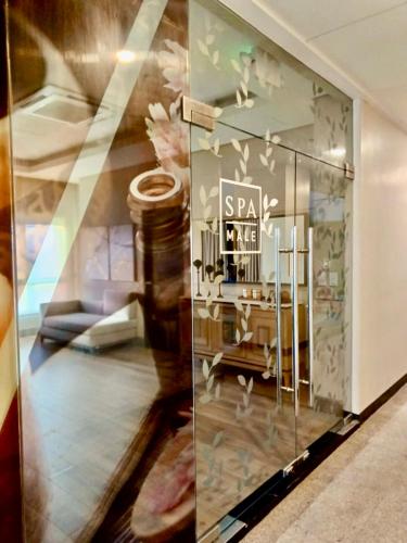 a display window in a store with a dressing room at Saint Honore Executive 1 Full bed, 1 Sofa bed 1 Pull out bed 2BR in Iloilo City