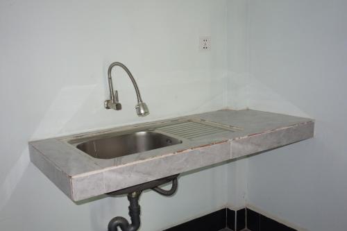 a stainless steel sink in a white wall at AHHA Bungalow Kampot in Kampot