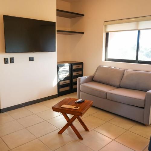 a living room with a couch and a coffee table at SUITES LOMBOY & PLAZA in San José del Cabo