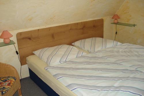 Bett in einem Zimmer mit zwei Lampen oben in der Unterkunft Apartment Neuendorf - Hiddensee 1 in Neuendorf