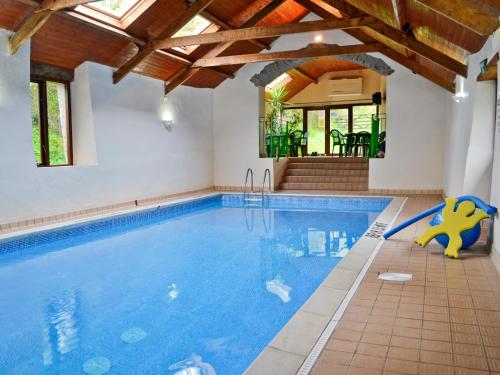 a swimming pool with a slide in a house at Bracken Cottage-B5817 in Wheddon Cross