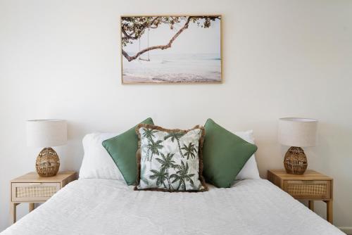 a bedroom with a bed with two night stands at Seashells - 3BR Marcoola Beach Resort in Marcoola