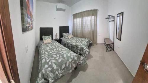 a room with two beds and a window in it at casa estefania in San Carlos