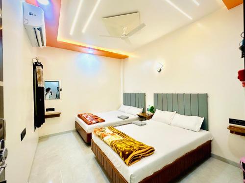 a hotel room with two beds in a room at Shiv Guest house in Ellora