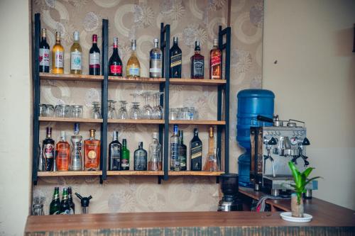 a shelf filled with bottles of alcohol on a wall at Hotel KR Mandap in Pokhara