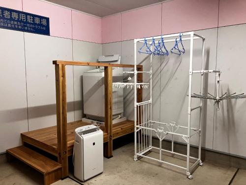 a room with a sink and a refrigerator in a room at Wonder House in Shingū