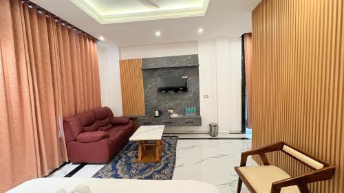 a living room with a couch and a fireplace at Orchha River Stone Resort in Orchha