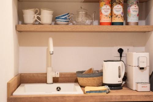 a kitchen counter with a sink and a coffee maker at Verde romantico in Città della Pieve