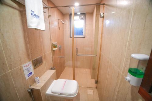 a bathroom with a shower and a toilet at The Altruist Andheri Hotel in Mumbai
