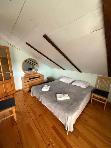 a bedroom with a bed and a dresser and a mirror at Guest House Seno in Dilijan