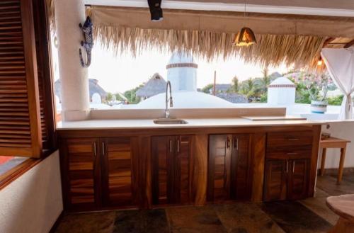a kitchen with a sink and a window at Luxury Casa Cindy in Puerto Escondido