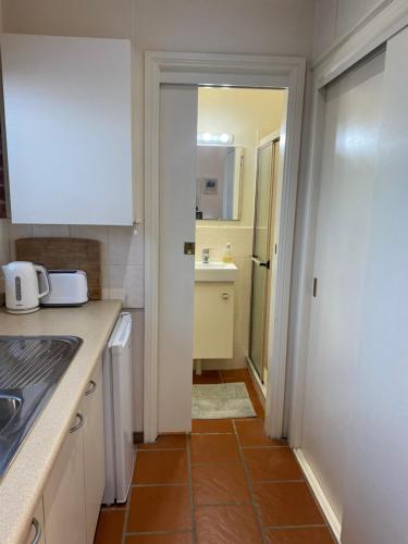 a kitchen with a sink and a counter top at Ciara's Cottage CC'S in Illawong