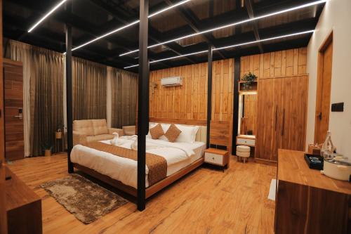 a bedroom with a canopy bed in a room at HoneyStone Resort in Sultan Bathery