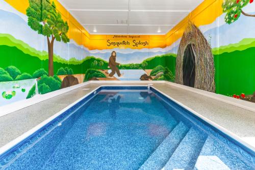 a swimming pool in a house with a mural at Sasquatch Splash Premier Private Pool Cabin with Hot Tub, Mtn Views, Arcade Games, Excellent Location in Pigeon Forge