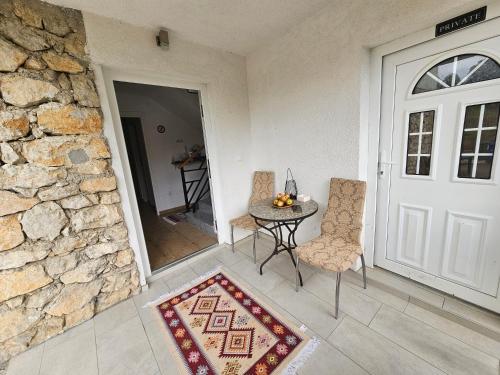 a room with a door and a table and chairs at Villa Ruscello in Grabovac