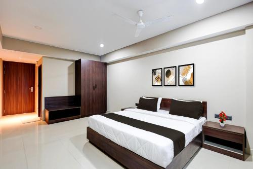 a bedroom with a large bed and a television at Townhouse GIDC Ankleshwar Formerly Studio 60 in Kosamri