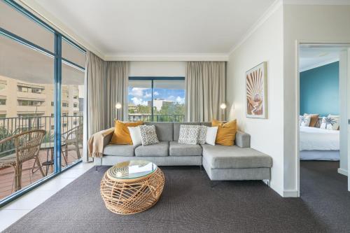 a living room with a couch and a bed at Spacious Darwin Esplanade Retreat with Pool & Spa in Darwin
