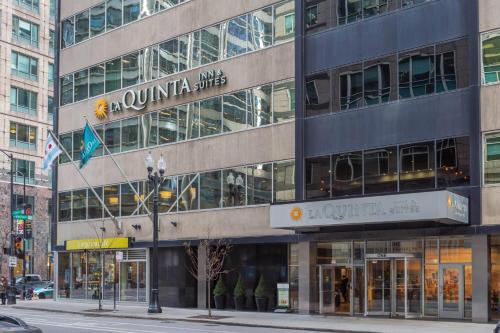 a tall building on a city street with a store at La Quinta Inn & Suites by Wyndham Chicago Downtown in Chicago