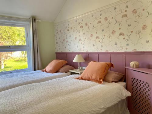 a bedroom with two beds and a window at Bronafon in Rhyl