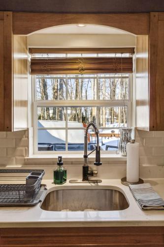 a kitchen with a sink and a window at Summit Chalet at Stillwater in Pocono Summit