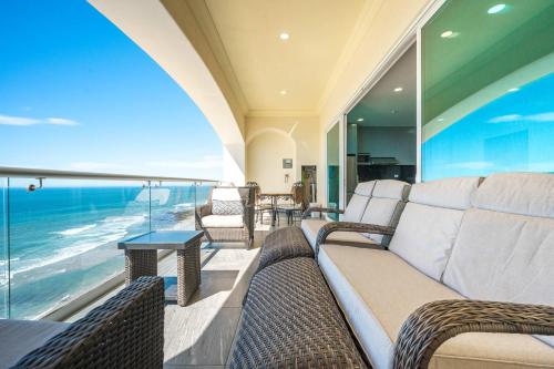 a living room with a couch and a view of the ocean at Mar y Sol 15th Floor 3BR 2 BA Condo with pool in Rosarito