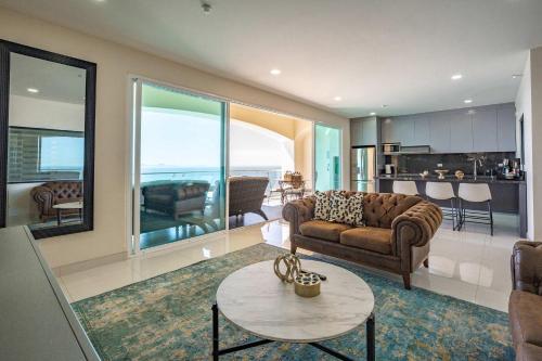 a living room with a couch and a table at Mar y Sol 15th Floor 3BR 2 BA Condo with pool in Rosarito