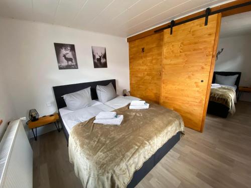 a bedroom with a bed with two towels on it at Deer Lounge in Bad Liebenstein