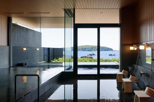 a large lobby with a view of the water at Fairfield by Marriott Wakayama Kumano Kodo Susami in Susami