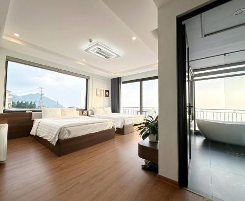 a bedroom with a bathtub and a bed and a tub at Time Villa in Tam Ðảo